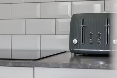 a toaster sitting on a counter in a kitchen at Abbey House in Paisley
