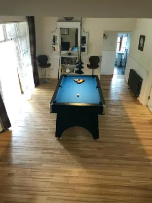 a pool table in the middle of a living room at The Coach House in Skelmorlie