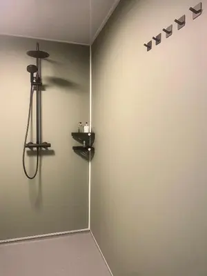 a corner of a room with a wall with a shower at Lochside Guest House in Arrochar