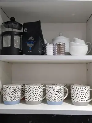 a shelf with a bunch of cups and a bag at Carnegie Place in East Kilbride