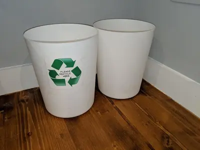 two white trash cans sitting on a wooden floor at Falcon Crest Guest House in Edinburgh