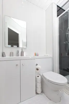 a white bathroom with a toilet and a mirror at Super Prime Park View Duloch by TBA in Dunfermline