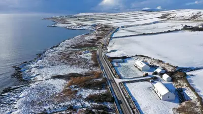 an aerial view of a road next to the water at Portbahn, Bruichladdich in Bruichladdich