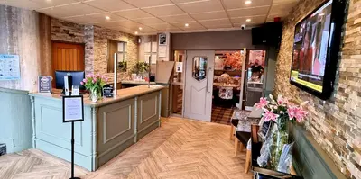 a restaurant with a counter and a bar in a room at Mill & Brae in Paisley