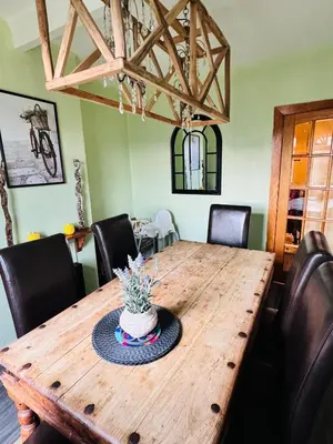 a dining room table with a cake on top of it at Park Road Holiday Home - Spacious 3 bedroom house with garden near Edinburgh in Rosyth