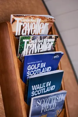 a shelf with a bunch of books on it at Luxury Hideaways in Keilour