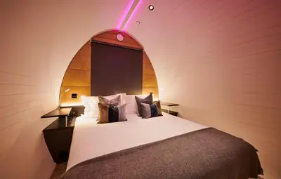 a bedroom with a bed with an arch above it at Luxury Hideaways in Keilour