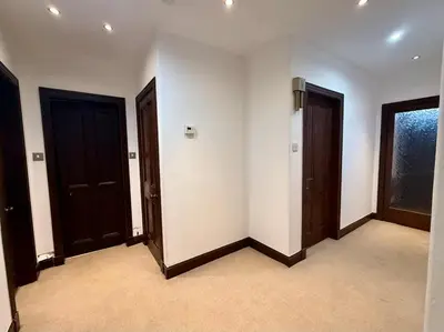 a empty room with two doors and a window at The Orchard Hotel in Falkirk
