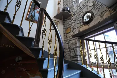 a staircase with blue steps and a stone wall at The Orchard Hotel in Falkirk