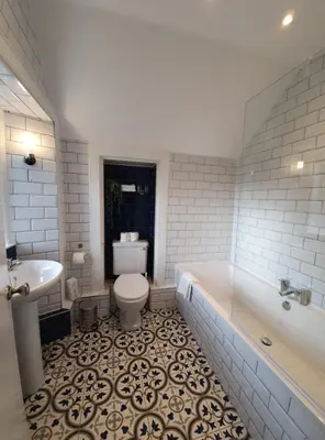 a bathroom with a tub and a toilet and a sink at Achray House Restaurant with Rooms in Saint Fillans