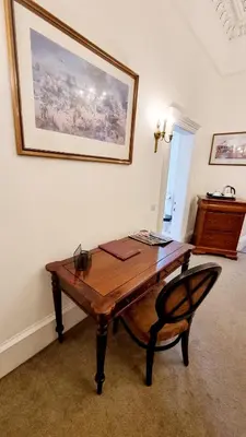 a wooden table and a chair in a room at The Guards Hotel in Edinburgh