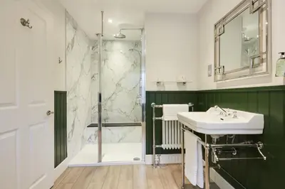 a bathroom with a sink and a shower at Merlindale in Crieff