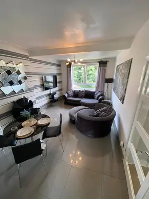 a living room with a couch and a table at Modern Quiet City Center Airport 2 Bedroom Apartment in Edinburgh