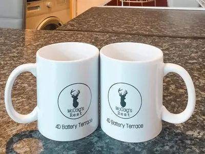 two white coffee mugs sitting on top of a counter at Apartment D 4 Battery Terrace Oban in Oban