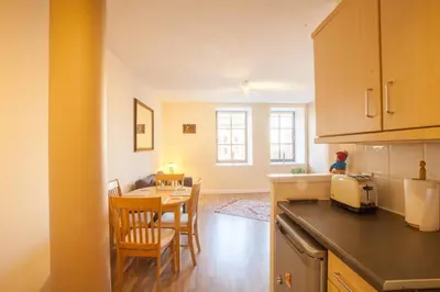 a kitchen and dining room with a table and chairs at Stylish Merchant City Flat in Glasgow