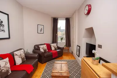 a living room with a couch and a table at Beautiful 2 Bed Apartment Rose St in Glasgow
