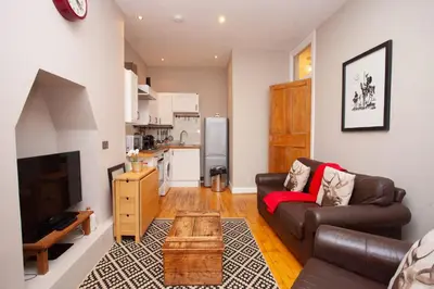 a living room with a couch and a table at Beautiful 2 Bed Apartment Rose St in Glasgow