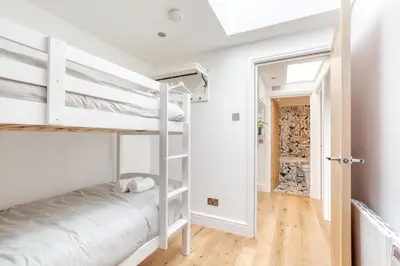 a room with two bunk beds and a hallway at Central Bright 3 Bed Flat with Pool & Parking in Edinburgh