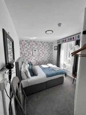 a bedroom with a bed and a tv in it at Islay Frigate Hotel in Tarbert