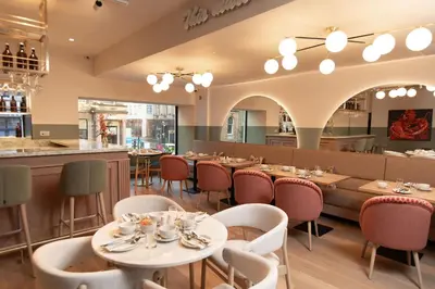 a restaurant with tables and chairs and a bar at The Address Glasgow in Glasgow