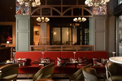 a dining room with tables and chairs in a restaurant at The Address Glasgow in Glasgow