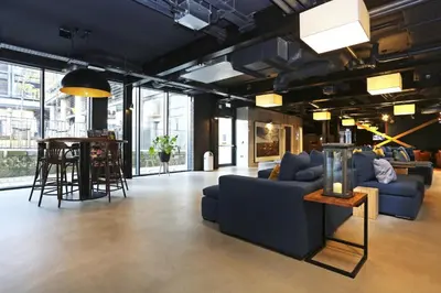 a living room with a blue couch and a table at JOIVY at VITA Fountainbridge - Adults only - Breakfast buffet in Edinburgh