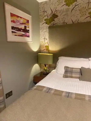 a bedroom with a bed and a picture on the wall at Aspen Lodge in Oban