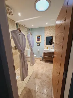 a bathroom with a shower and a sink and a tub at Aspen Lodge in Oban