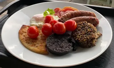 a plate of breakfast foods on a table at Aspen Lodge in Oban