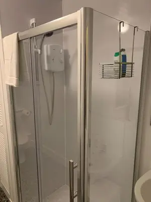 a shower with a glass door in a bathroom at Apartment 39c in Oban