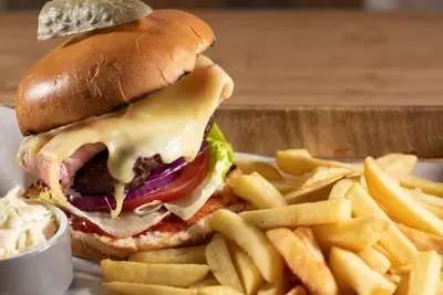 a sandwich and french fries on a white plate at Livingston Lodge Hotel in Livingston
