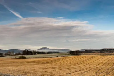 a field with a view of a mountain in the distance at Thornhill Lodge, Historic 4 Bed, 4 Ensuite in Stirling
