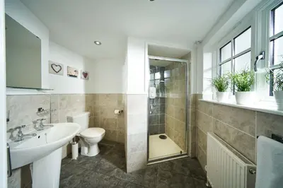 a bathroom with a sink and a toilet and a shower at Thornhill Lodge, Historic 4 Bed, 4 Ensuite in Stirling