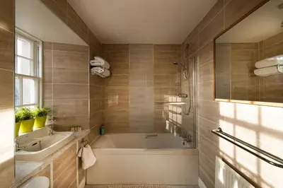 a bathroom with a tub and a sink at Thornhill House - Historic 5 Bedroom 5 Ensuite in Stirling