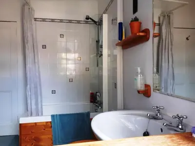 a bathroom with a tub and a sink and a shower at North Lodge of Orchil in Braco