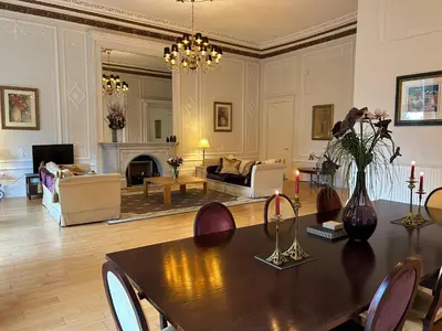 a living room with a dining table and a living room at Grand in the Park in Glasgow