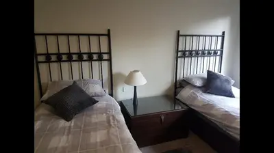 a bedroom with two beds and a lamp on a table at Luxury 2Bedroom Lodge in Auchterarder