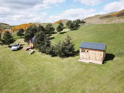 an overhead view of a small house in a field at Little Lochan Lodge in Glenfarg
