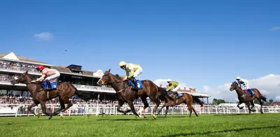 a group of horses racing in a horse race at Kintyre Apartment in Ayr