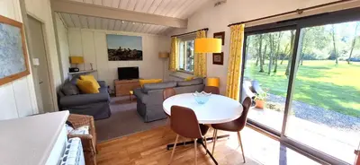 a living room with a table and a couch at Lochend Chalets in Port of Menteith