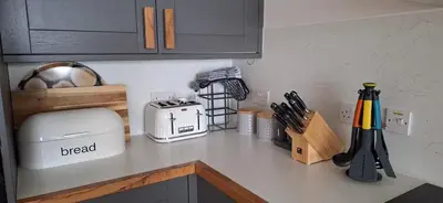 a kitchen counter with a white toaster and a toaster at Lochend Chalets in Port of Menteith