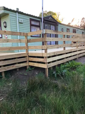 a wooden fence in front of a trailer at Lyndhurst 28 in Dunoon