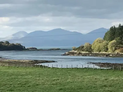 a view of a river with mountains in the background at The West Highland Way Campsite & Campervan Accommodation in Milngavie