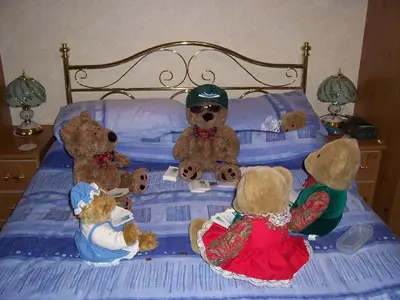 a group of stuffed teddy bears sitting on a bed at Sunnyside B&B in Balloch