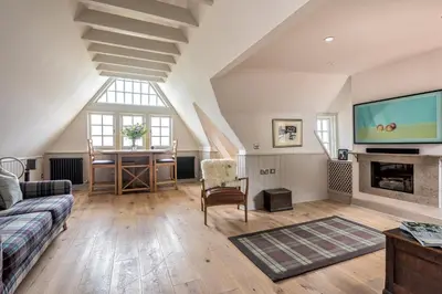 a living room with a couch and a tv at Amazing penthouse, stunning views, Castle 2 mins in Edinburgh