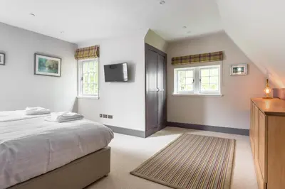 a bedroom with a bed and a tv on the wall at Amazing penthouse, stunning views, Castle 2 mins in Edinburgh