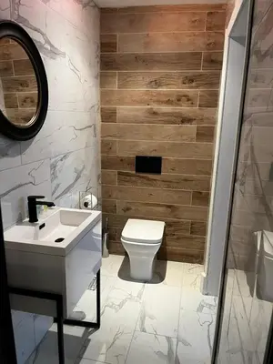 a bathroom with a toilet and a sink and a mirror at WEST END -Stunning, 2 bedroom, main door flat with private parking in Glasgow