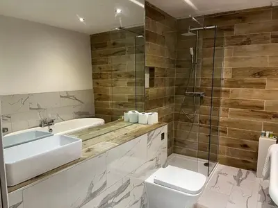 a bathroom with a sink and a toilet and a shower at WEST END -Stunning, 2 bedroom, main door flat with private parking in Glasgow