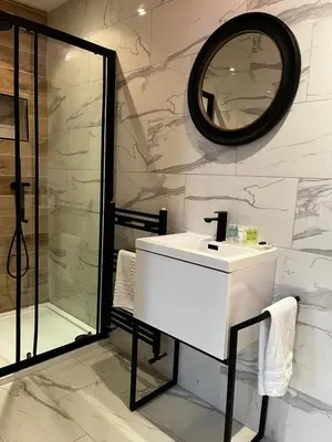 a bathroom with a white sink and a shower at WEST END -Stunning, 2 bedroom, main door flat with private parking in Glasgow