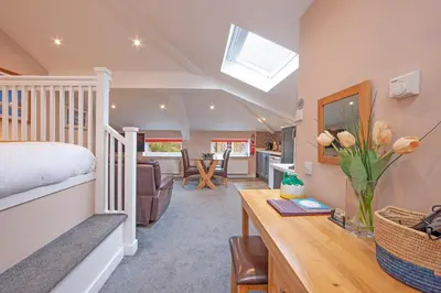 a bedroom with a bed and a desk in a room at Mandarin Premier Apartments B - Loft studio apt in Oban
